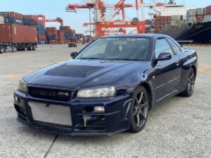 The Nissan Skyline GT-R R34 was produced from 1999 to 2002. This particular car, finished in the iconic Midnight Purple II (a color-shifting paint that appears deep blue or purple depending on the light), is one of only a few hundred examples produced in this specific shade, making it highly desirable from the moment it left the factory.